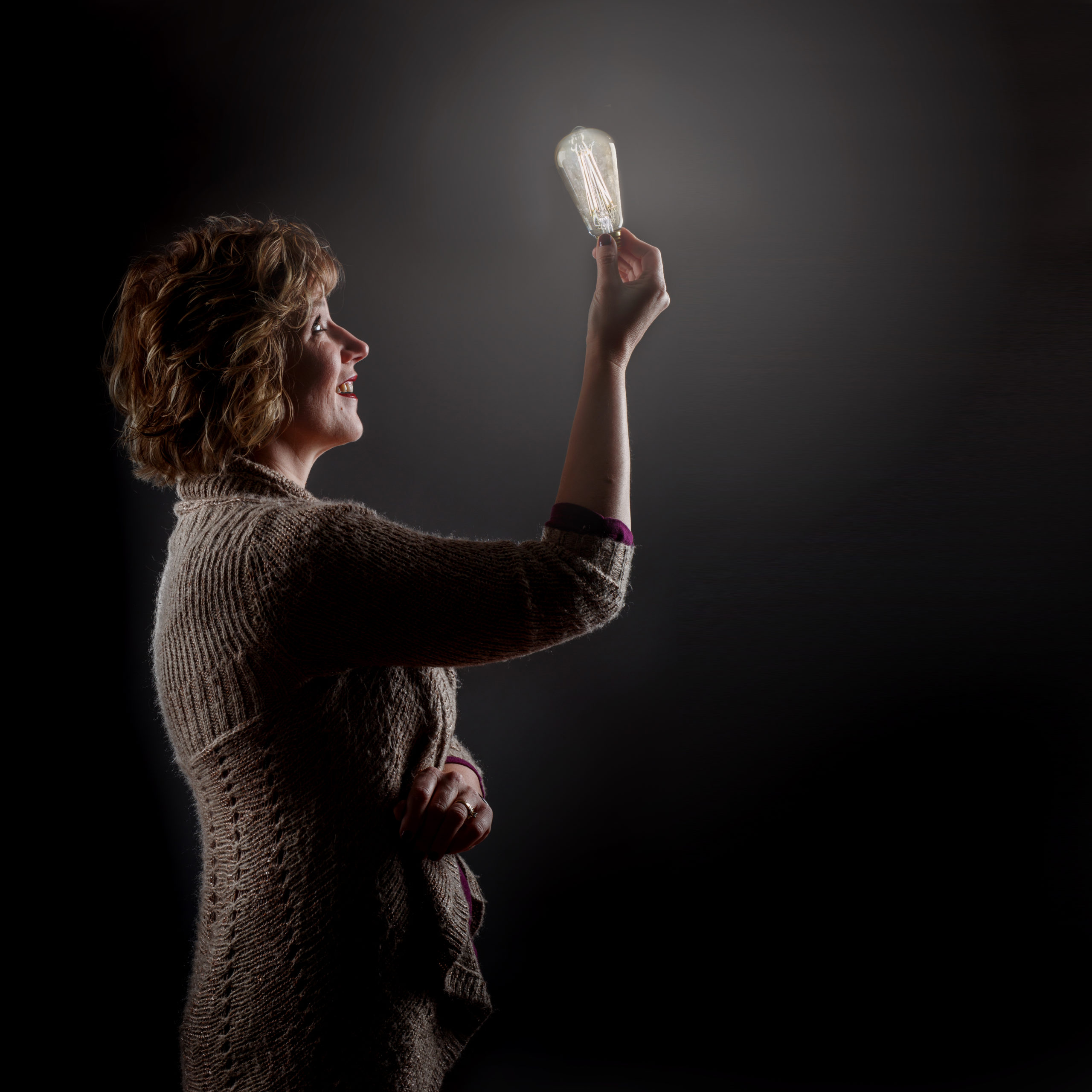 Becky Rogers holding a lightbulb
